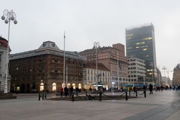 Tourists walking on ban jelacic square in zagreb at dusk