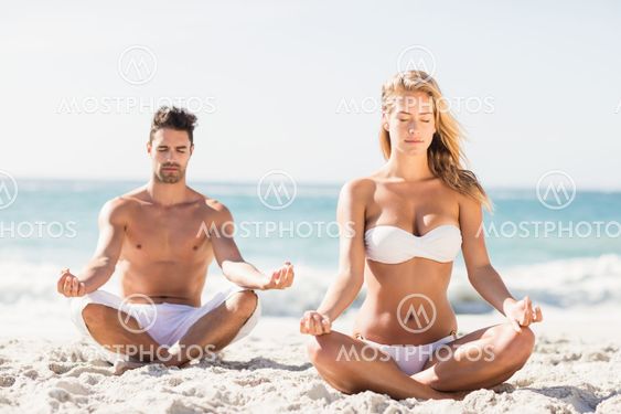 Happy couple doing yoga