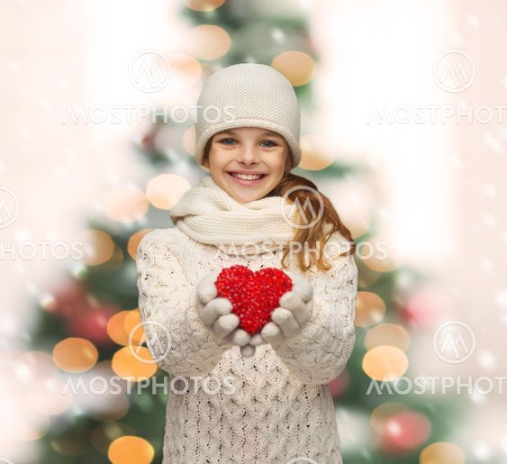 girl in winter clothes with small red heart