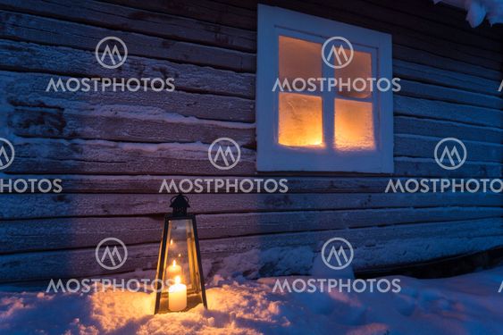 Lantern outside a cottage with frosty window
