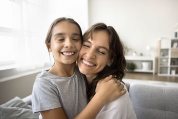 Close up faces cheerful beautiful mother and little...
