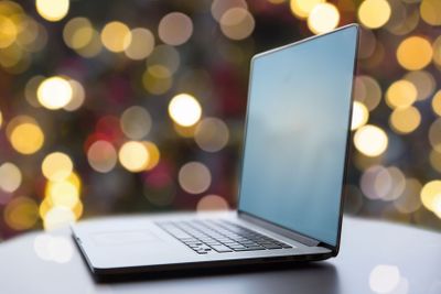 laptop and coffee cup on table at christmas
