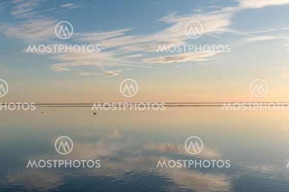 White clouds reflecting in calm water