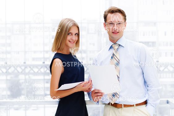 business man and business woman in the office to discuss reports