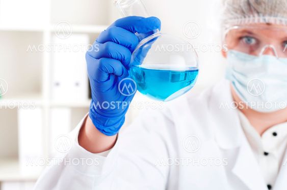female chemist mixing liquids in test tubes
