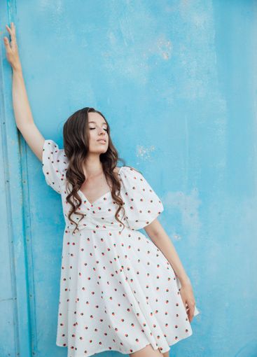 slim fashion brunette woman in summer white dress on...