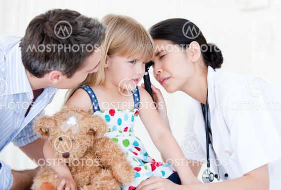 Radiant female doctor examining little girl with medical equipment