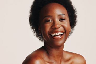 Beauty, smile and portrait of black woman in studio for...