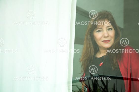 Mature woman looking out the window