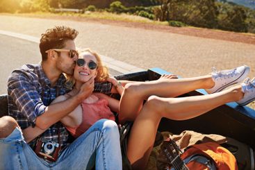 Kiss, journey and happy couple on road trip for travel,...