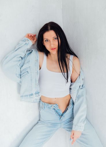 Beautiful slim fashion brunette woman in denim suit