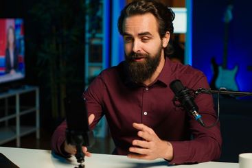 Man using microphone and mobile phone to film ASMR video