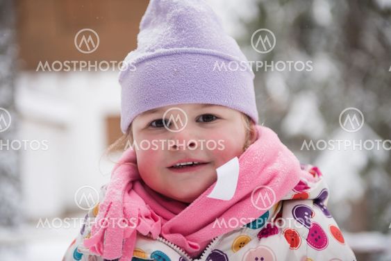 little girl have fun at snowy winter day