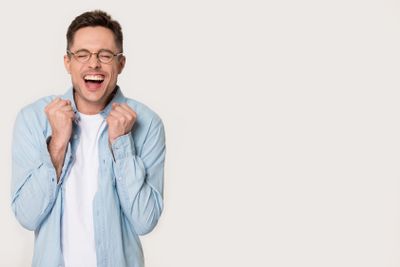 Overjoyed funny man celebrating joy standing aside on...