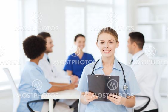 happy doctor over group of medics at hospital