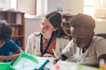 Write, education and teacher helping children in...