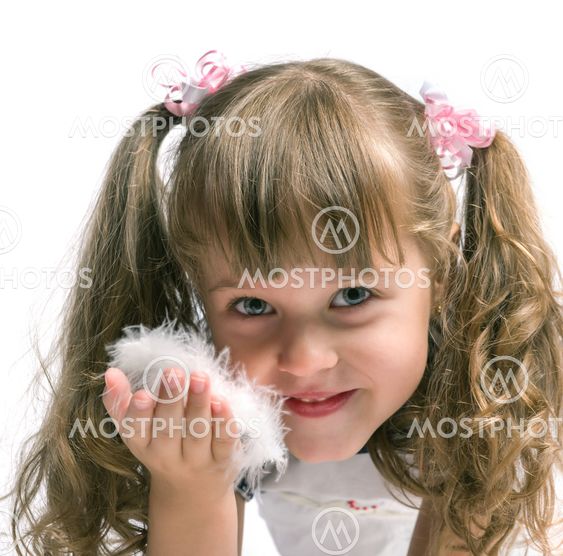 little girl blowing on a feather on a white background, isolated