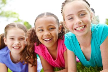 Children, grass and girls together in portrait, natural...