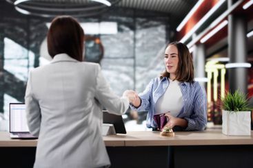 Hotel Receptionist Welcoming Businesswoman, Arranging...