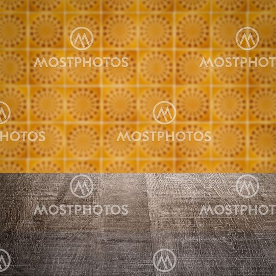 Wood table top and blur vintage ceramic tile pattern wall