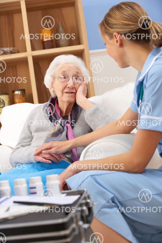 UK nurse visiting senior woman at home