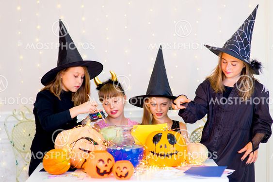 Happy group of teenagers in costumes preparing for...