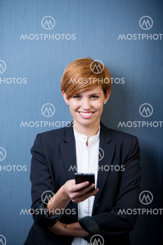 Businesswoman Text Messaging On Mobile Phone