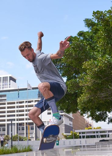 Man, jump and skateboard with trick or rail for parkour...