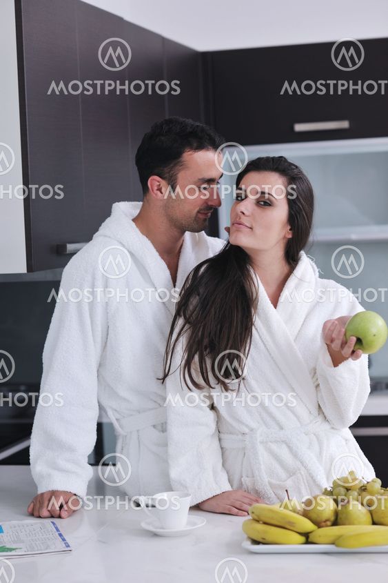 young couple have fun in modern kitchen