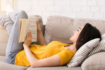 Quarantine leisure activities. Intelligent woman reading...