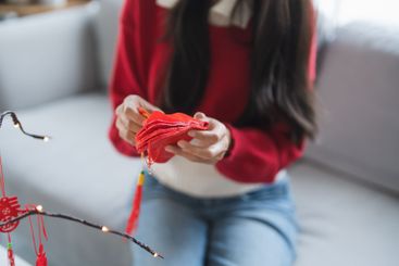 Asian Woman decorated house for Chinese New Year...