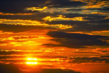 striking post-sunset sky, with a dynamic array of red...