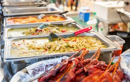 Delicious Asian street food market with takeaway meals,...