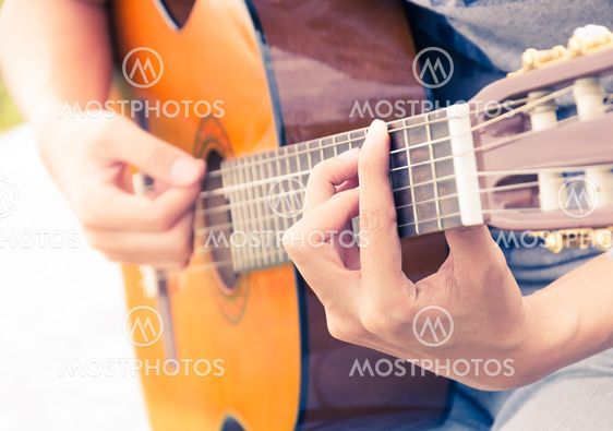 hand playing on guitar