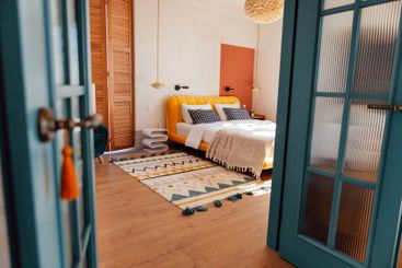 A cozy bedroom with white walls. An open stylish blue...