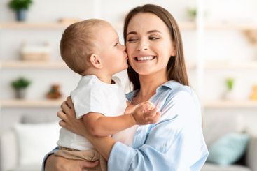 Mother Child Love. Cute Little Baby Boy Kissing Happy...