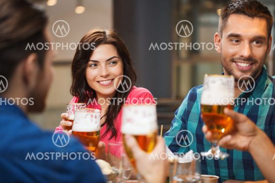 friends dining and drinking beer at restaurant