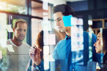 Man, writing and team at glass for creativity,...