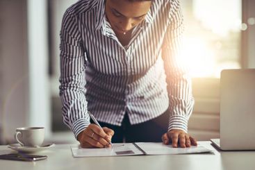 Desk, writing and woman with document, business and...