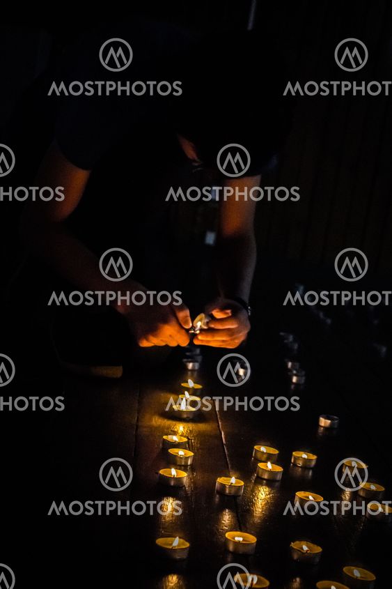 A guy lights candles