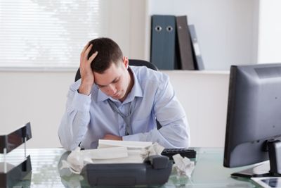 Businessman frustrated by paperwork