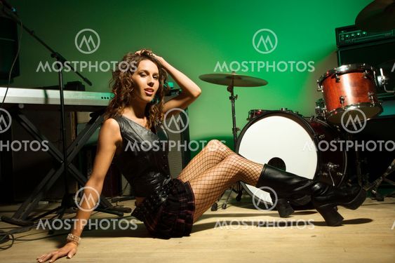 Female posing with instruments.