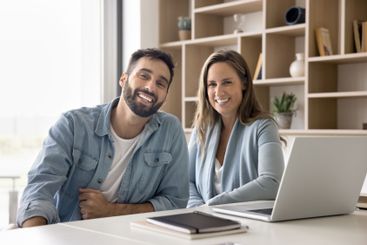 Portrait of two successful businesspeople posing...