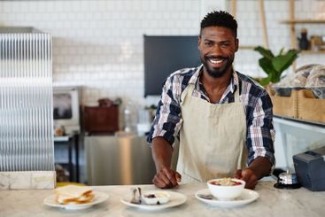 Man, barista and food waiter in cafe, professional and...