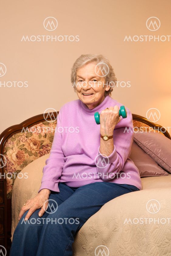 Mature woman lifting weight.