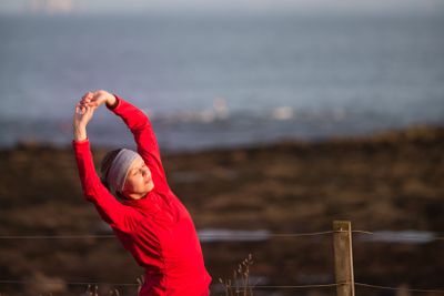 Young woman on her evening jog along the seacoast