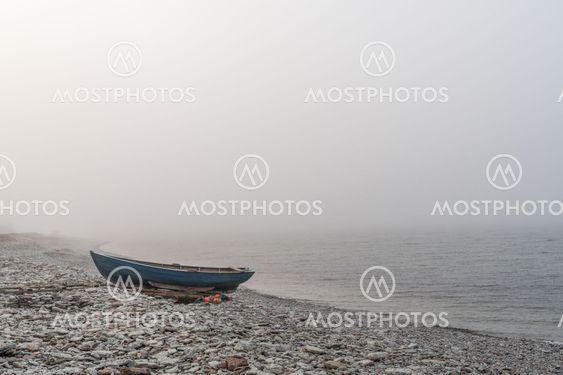 Lone landed rowboat by seaside