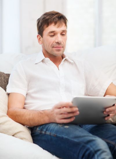 man working with tablet pc at home