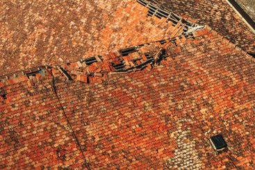 Texture of and old ruined roof, worn vintage roof tile...