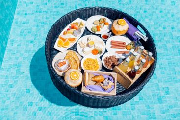 A floating breakfast tray with various dishes and drinks...